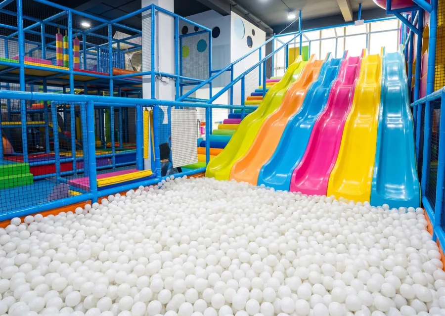 Resbaladilla hacia alberca de pelotas en juegos infantiles